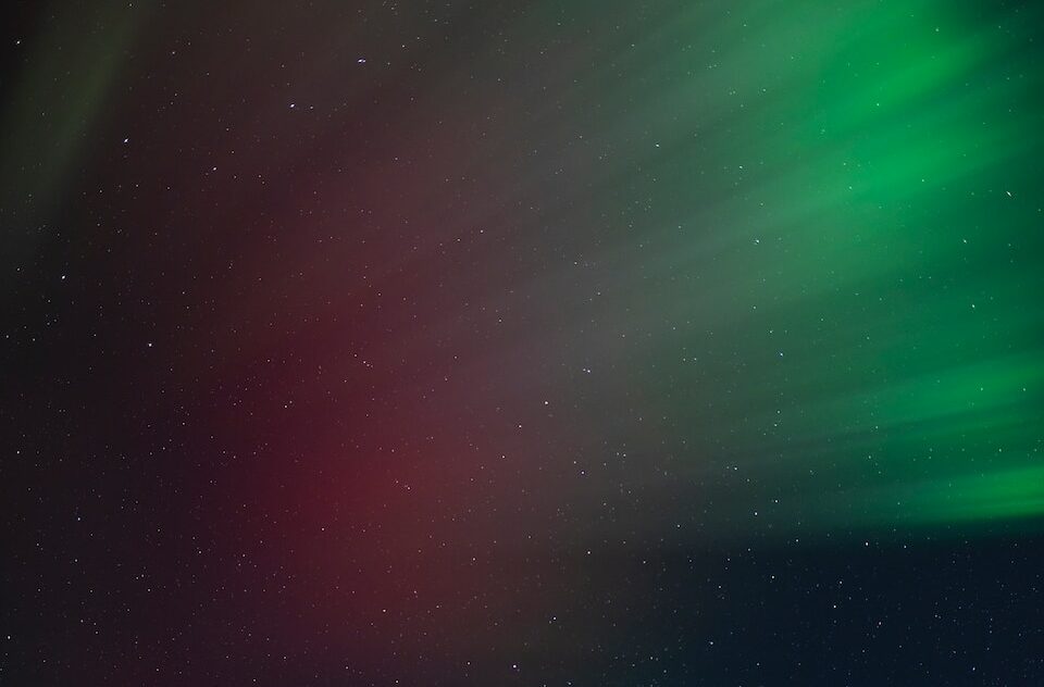 a bright green and red aurora bore in the sky